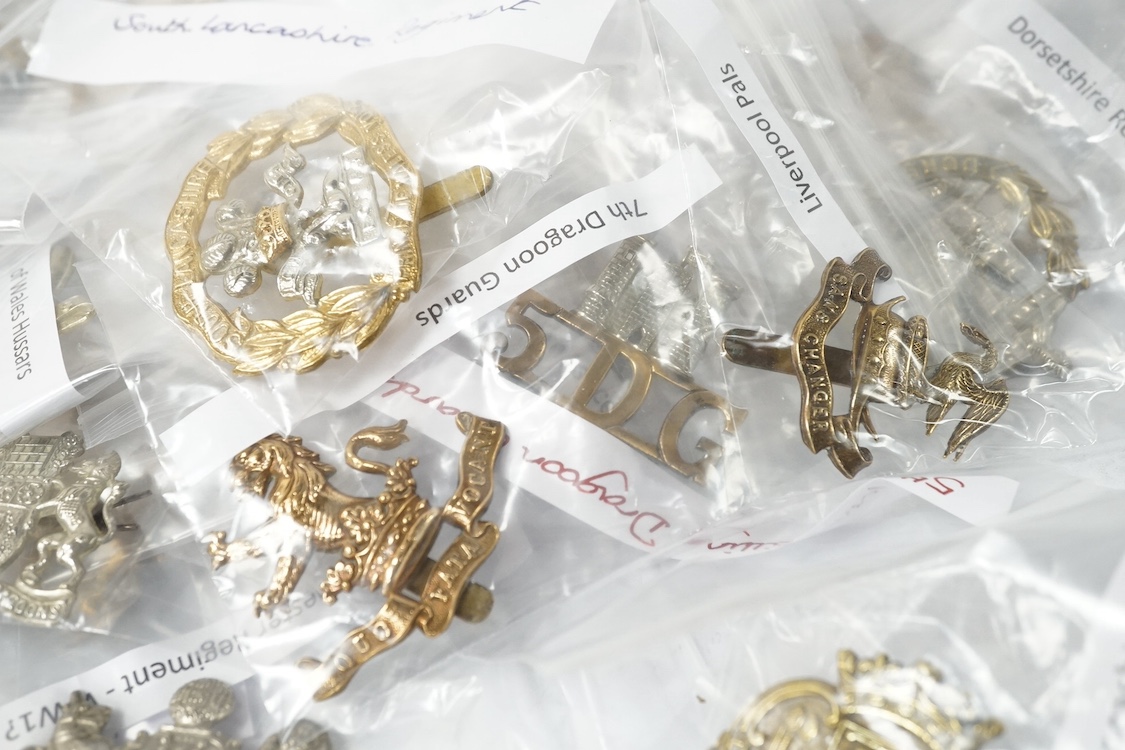 Fifty military cap badges including; the Norfolk regiment, the 16th Queen’s Lancers, Army Education Corps, Bedfordshire Yeomanry, Princess Victoria‘s Royal Irish Fusiliers, Northamptonshire Yeomanry, Royal Naval Division